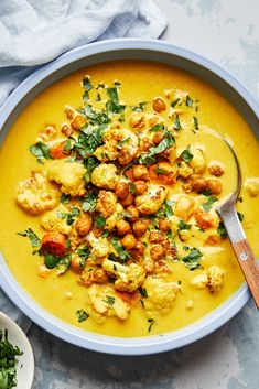 a bowl filled with cauliflower and garnished with parsley