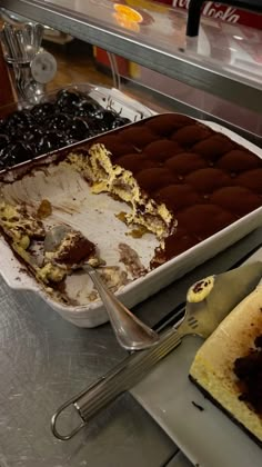 an ice cream cake with chocolate icing and cherries on the side, next to a fork