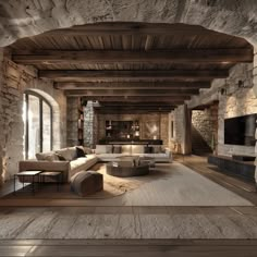 a large living room with stone walls and wooden floors