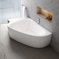 a white bath tub sitting on top of a tiled floor