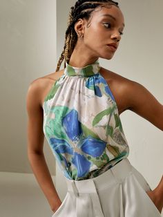 Crafted from crepe de chine, Praslin Silk Top features a mock neck and sleeveless cut. The eye-catching botanical pattern perfectly complements the beach-inspired design, adding a touch of whimsy and vibrant energy to your wardrobe.