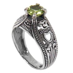 A single faceted peridot twinkles in bright spring green atop this solitaire ring with a handcrafted sterling silver band with openwork heart motifs. Indonesia's Agung Jagra handcrafts his design inspired by the beauty and rich culture of his home. Green Crystal Ring With Center Stone As Gift, Green Crystal Ring With Center Stone For Gift, Green May Birthstone Promise Jewelry, Green Crystal Ring With Center Stone For May Birthstone, Classic Green Jewelry For Promise Occasions, Green Promise Ring With May Birthstone, Green Promise Rings With Bezel Setting, Classic Peridot Green Rings, Green May Birthstone Promise Ring