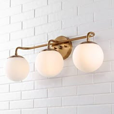 three lights on a white brick wall