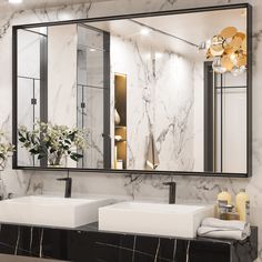 a bathroom with two sinks and a large mirror on the wall above it that has gold accents