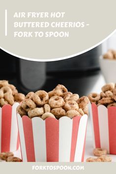 three red and white striped paper cups filled with cereal