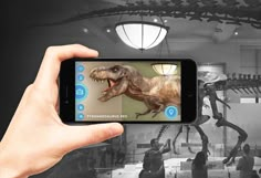 a person taking a photo of a dinosaur in a museum with their cell phone screen