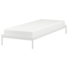 a white bed frame with no sheets on it