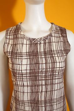 "Cool Vintage 60s 70s Brown & Off-White Hatchmark Pattern Sleeveless Top Has stretch. Bust 17\" (laid flat) Length, Top to Bottom 22\" Bottom Opening 17.5\" (laid flat) Arm Opening 7.5\" (laid flat) Tag: Size 8 / 100% Polyester / Made in California Condition: 2 Condition Scale: 1-Immaculate Vintage Condition (Rare) 2-Unnoticeable Vintage Wear or Spots that are unphotographable 3-Small Noticable Vintage Wear or Spots, as photographed 4-A Lot of Noticable Vintage Wear or Spots, as photographed Spring Sleeveless Lined Top, Retro Fitted Summer Vest, Retro Fitted Vest For Summer, Retro Fitted Cotton Tank Top, Fitted Retro Cotton Tank Top, Retro Fitted Sleeveless Tank Top, Fitted Retro Sleeveless Tank Top, Vintage Sleeveless Brown Top, Retro Fitted Sleeveless Vest