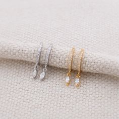 Elevate your outfit with these minimalist dainty huggie hoop earrings crafted from high-quality 925 sterling silver and premium diamond CZ. These dainty earrings are a timeless addition to any outfir. - INNER Diameter: 9mm   - Material: Core material is sterling silver with silver or 18K gold finish, Premium diamond CZ, Hypoallergenic,  - Turnaround time: Same day or Next day delivery guaranteed  - Qty: 1 pair - Individually inspected by DK and packed in a gift jewelry box as shown in photo  - Please ask me any questions ! I am quick to reply :) Thank you for visiting my shop  - For shop policies, please visit: https://www.etsy.com/shop/DoodleJewelrybyDKArt Dainty Diamond Huggie Earrings As A Gift, Dainty Cubic Zirconia Small Hoop Huggie Earrings, Dainty Diamond Dangle Huggie Earrings, Gift Diamond Accent Dangle Huggie Earrings, Dainty Diamond-cut Hoop Earrings For Gifts, Stacking Earrings, Earrings Stacking, Meaningful Gifts For Her, Hoop Dangle Earrings