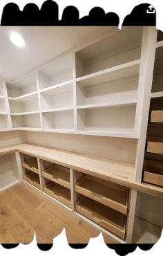 an empty room with white shelves and drawers