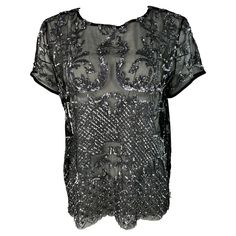 Product details: The t- shirt features crew neck line, short sleeves, see through style with floral motif. It is shorter on the front and longer on the back. Front: 23.25” long. Back: 30” long. Sequin Top, Helmut Lang, Issey Miyake, Neck Line, Black Mesh, Cami Tops, Floral Motif, Metallic Silver, Sweat Shirt