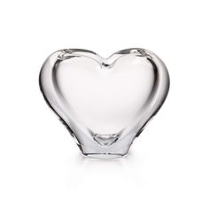 a glass heart shaped vase on a white background