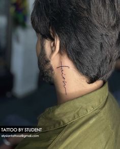 the back of a man's neck has a tattoo on it that says faith