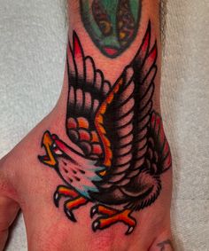 a hand with an eagle tattoo on it