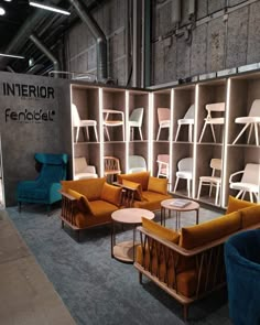 a room filled with lots of furniture next to a book shelf full of chairs and tables