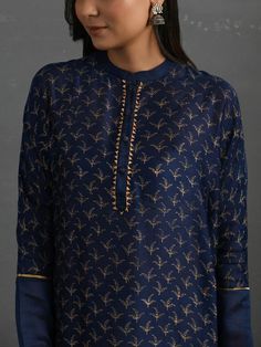 A free-size flowy Indigo chanderi kurta with gold block print, gota detail and pleated hem. Garment measurements (in Inches): Free size: Length - 47", Bust - 61", Waist - 60" Fabric: Chanderi (Cotton silk) Color: Indigo Fit: Model height - 5"7" Fit - Loose/comfortable Technique: Hand block printed in gold with gotta details Instructions: Dry clean only Note: Available in other colors This product will be shipped within 20-25 days of the order placed Gold Long Sleeve Slub Silk Kurta, Traditional Silk Palazzo Set With Block Print, Designer Silk Kurta With Block Print, Transitional Silk Kurta With Printed Motifs, Long Sleeve Cotton Silk Kurta With Gota Work, Silk Straight Kurta Tunic For Eid, Elegant Kurta With Printed Motifs For Navratri, Elegant Navratri Kurta With Printed Motifs, Silk Kurta With Block Print And Long Sleeves