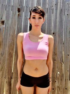 "This form-fitting pink crop top / cropped tank top is made from a stretchy cotton spandex fabric.   Best paired with: Jeans, cutoff shorts, yoga pants, or your favorite mini-skirt. The model is 5'6\" and wearing a size small. The fabric is stretchy and adjusts to the shape of your body. Size Chart (inches):                              S            M           L Bust                      26-30 30-34    34-36 Natural Waist        23            24    26 Length                       12             13     14  Materials:  95% cotton, 5% spandex. Custom print on this crop top: Yes. You can request your own design on this crop top. There is a $16 custom design fee added to the price of the top. Local Pickup Available: Yes.  If you live in the south bay area in San Diego, you can pick up your cro Body Size Chart, Home Clothes Women, Belly Top, Belly Shirt, Belly Shirts, Crop Tops For Women, Cutoff Shorts, South Bay, Pink Crop Top