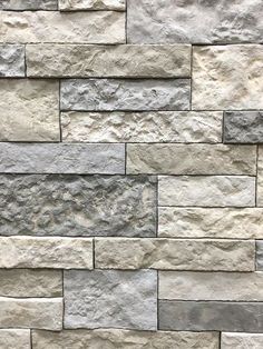 a stone wall that is made out of different colors