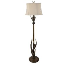 an antler lamp with a white shade on it's base and a brown floor lamp