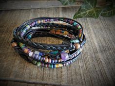 "This Wrap Bracelet for Women is so fun!, boho wrap brackets are so versatile, a bracelet you can wear every day. Amethyst Layering Bracelets are a great the summer look. ... Natural (will get darker with time) Napa leather braided, multi cord bracelet. A unique combination of High-fired stoneware, recycled glass, fresh water pearl and semi-precious stone beads combine to make this 3x wrap bracelet. It is adorned with a magnetic clasp that makes it very easy to put on by yourself. (4) SizesExtra Hippie Hand Wrapped Braided Bracelets For Friendship, Adjustable Hippie Style Friendship Wrap Bracelet, Bohemian Adjustable Braided Bracelets, Hand Wrapped, Bohemian Hand Wrapped Braided Bracelets, Hippie Hand Wrapped Jewelry For Friendship, Bohemian Braided Friendship Bracelets, Bohemian Hand Wrapped Bracelets For Festivals, Adjustable Multicolor Bohemian Wrap Bracelet, Adjustable Bohemian Wrap Bracelet