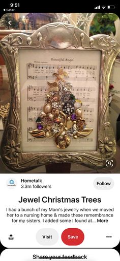 a christmas tree made out of old sheet music is displayed in an ornate gold frame