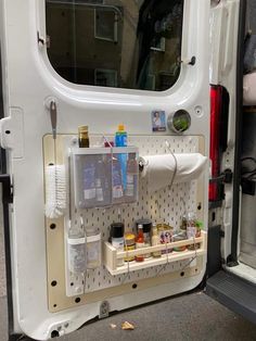 the back door of a white van filled with spices and condiments on it