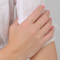 Make a sparkly statement with our Bezel eternity ring set with round grade 5A CZ's. It has the wow factor to be worn alone or stacked with our other rings. - Made in gold vermeil: a thick 18k gold layer on sterling silver.- Band thickness: 3.2 mm.- Shower safe, tarnish resistant & hypoallergenic Ring Size Chart. If you are in between sizes, we recommend sizing up. Dazzling Yellow Gold Eternity Band For Promise Ring, Dazzling Yellow Gold Eternity Band As Promise Ring, Gold Cubic Zirconia Half Eternity Diamond Ring, Dazzling Stackable Promise Rings, Dazzling Promise Stackable Rings, Gold Cubic Zirconia Eternity Band With Prong Setting, Dazzling Gold Eternity Band With Prong Setting, Yellow Gold Cubic Zirconia Rings With Bezel Setting, Yellow Gold Rings With Bezel Set Cubic Zirconia