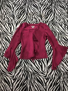 "90s Vintage Bell Sleeve Ruffle Blouse in Shiny Deep Magenta Color I'm in love with this beautiful, romantic style magenta blouse! Ruffle accent down the front and flowy bell sleeves. Reminds me of a medieval style sleeve. Gorgeous deep purple, magenta jewel tone color. The fabric is a polyester but has a sheen to it like a polyester taffeta. This color photographs as a red wine tone but in real life there's a little more purple in it. Made in USA Brand: J.B.S. Ltd Tag Size: Small Measurements ( Pink Bell Sleeve Tops For Summer, Flirty Fitted V-neck Blouse, Vintage Fitted Bell Sleeve Tops, 90s V-neck Tops For Fall, Flirty Long Sleeve Blouse For Spring, Flirty Ruffled Tops For Fall, Long Sleeve Ruffled Tops For Night Out, Fitted 90s Tops For Fall, Long Sleeve Ruffle Tops For Night Out