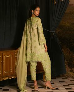 Illuminate your wardrobe with this kiwi green embroidered kurta and salwar set. The suit features a pearl and cutdana embroidered shirt that adds a touch of elegance, complemented by beautifully embroidered salwar pants. Completing the look is an organza scalloped embroidered dupatta, enhancing the ensemble's charm. Perfect for festive occasions, this outfit beautifully blends tradition with contemporary style, ensuring you make a lasting impression. Designer Green Embroidered Kurta, Green Embroidered Shantoon Kurta, Embroidered Green Organza Kurta, Semi-stitched Green Embroidered Kurta, Fitted Green Kurta With Cutdana Detail, Salwar Pants, Satin Color, Embroidered Shirt, Kiwi