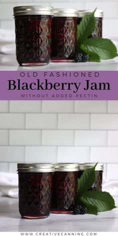 three jars filled with blackberry jam sitting on top of a white counter next to green leaves