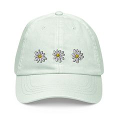 Gone may be the days of when we would make crowns of daisies, but that doesn't mean you have to stop wearing them on your head! This design is simple and sweet, just like you. Embroidery is machine-finished and polished-looking, promising for a cute addition to any summer 'fit. ABOUT THE PHYSICAL PRODUCT Classic cap shape features a curved visor with a high-quality adjustable buckle strap. Hat panels are unstructured for a casual fit. Comfortable and stylish choice, created with 100% chino cotto Holiday Hats, Summer Light, Pastel Mint, Unique Hats, Hat Summer, White Embroidery, Shrek, Baseball Hat, Phoenix Az