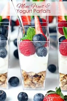 yogurt parfaits with berries and blueberries in small glass cups on a table