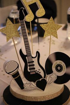 there is a cake that looks like an electric guitar and some music notes on it