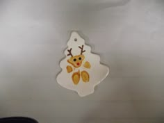 a white ceramic ornament with a reindeer on it