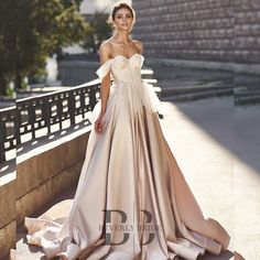 a woman in a wedding dress standing on some steps and posing for the camera with her hand on her hip