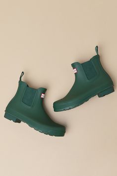 Romanticize rainy days with every step in the Hunter Original Hunter Green Chelsea Rain Boots! These matte rubber rain boots feature a rounded upper that rises to an ankle-high shaft with elastic gussets at the instep and outstep. The slip-on design features a pull tab and a ribbed-textured detail at the back, all atop a sturdy low-block heel. Logo tag at the front. Available in whole sizes only. 0. 75" rubber heel. Lightly cushioned insole. Rubber sole has nonskid markings. Man made materials. Green Waterproof Boots For Rainy Weather, Green Waterproof Boots For Rainy Season, Waterproof Green Boots For Rainy Season, Green Rain Boots For Rainy Season, Fall Ankle Rain Boots For Rainy Weather, Fall Ankle Rain Boots, Green Boots For Rainy Season, Fall Rainy Weather Ankle Boots, Casual Green Boots For Rainy Season