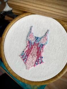 a close up of a embroidery on a wooden hoop