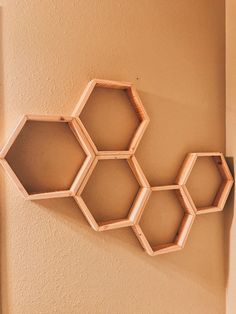 three hexagonal shelves mounted to the side of a wall