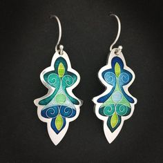 Teal and Blue Artemis Dangle Earrings - cloisonne and champleve vitreous enamels w/ sterling silver ear wires handmade by Sandra McEwenFeel like a goddess in these lovely Cloisonné and Champlevé enamel earrings!Dimensions: 18mm x 36mmMaterials: Vitreous Enamels on fine silver.  Sterling silver ear wires.Did you know that enamels are melted glass?  Yes!  It's true...  To create this lovely pair of earrings, I first fabricated the silver base out of sheets of fine silver.  The lines of the design Green Enamel Earrings With Artistic Design, Hand Painted Sterling Silver Dangle Jewelry, Unique Silver Enamel Earrings, Artisan Green Earrings With Artistic Design, Green Hand Painted Sterling Silver Earrings, Artisan Enamel Jewelry With Ear Wire, Green Artisan Enamel Earrings, Artisan Green Enamel Earrings, Artistic Silver Enamel Earrings