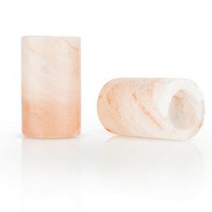 two pieces of white marble sitting next to each other on top of a white surface