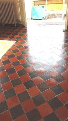 an orange and black tiled floor in a room