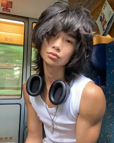 a man wearing headphones on a train