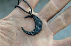 The crescent as a symbol does not need any special descriptions, since it has a multitude of meanings to different people. Each one of these amulets is hand forged and thus every one is unique. Crescent pendants are available as black mild steel versions and metallic brushed stainless steel. Please note that the stainless steel version contains nickel and thus is not recommended for individuals with nickel allergy. Width: 30 mm (~1,2 inches) Height: 30 mm (~1,4 inches) The jewel cords available Unique Black Jewelry With Moon Phase, Symbolic Hand-forged Black Jewelry, Spiritual Hand-forged Crescent Jewelry, Symbolic Black Hand Cast Jewelry, Hand Forged Crescent Sterling Silver Necklace, Celestial Moon-shaped Hand Forged Jewelry, Symbolic Black Crescent Jewelry, Hand Forged Sterling Silver Crescent Necklace, Symbolic Black Necklace With Moon Charm