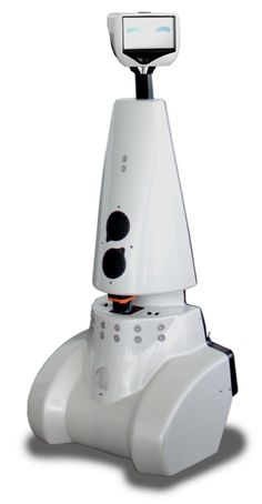 a robot that is sitting on top of a white surface with its head turned to the side