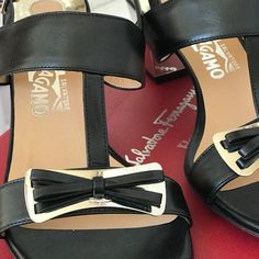 Brand New Slingback Black Leather Sandals With Silver Tone Bow. Never Worn 2.5" Block Silver-Tone Block Metal Heel Size 9b (Approx Conversion To Us Size 8) With Box No Dust Bag Made In Italy Formal Calf Leather Slingback Sandals With Block Heel, Luxury Calf Leather Slingback Sandals With Block Heel, Elegant Calf Leather Slingback Sandals With Block Heel, Luxury Sandals With Block Heel And Tang Buckle, Luxury Sandals With Tang Buckle And Block Heel, Classic Heels With Tang Buckle And Open Heel, Luxury Heels With Tang Buckle, Formal Block Heels With Tang Buckle, Luxury High Heel Slingback Sandals With Leather Lining