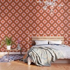 a bedroom with a bed, chandelier and rugs on the hardwood floor