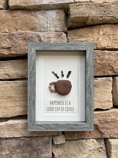 a frame with a handprint on it that says happiness is a good cup of coffee