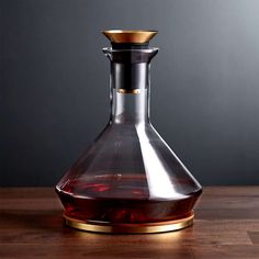 a glass decanter sitting on top of a wooden table