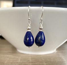 Lapis Lazuli Gemstone Sterling Silver Earrings - I made the earrings with 10mm x 15mm teardrop shape royal blue Lapis Lazuli semi precious gemstones, I wire- wrapped with Sterling Silver wire and Sterling Silver beads.  The earrings hang from .925 Sterling Silver earwires. The earrings measure 35mm long including the earwires The Lapis stones are dark royal blue colour with flecks of gold pyrite through the stones. All metal is .925 Sterling Silver I will send your earrings wrapped in crisp whit Classic Blue Teardrop Earrings, Blue Lapis Lazuli Teardrop Earrings, Blue Teardrop Lapis Lazuli Earrings, Sapphire Teardrop Gemstone Earrings, Blue Gemstone Teardrop Earrings, Lapis Lazuli Teardrop Jewelry With Matching Earrings, Teardrop Lapis Lazuli Jewelry With Matching Earrings, Nickel-free Teardrop Sapphire Earrings, Lapis Lazuli Teardrop Earrings For Gifts