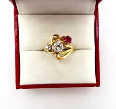 Contemporary Estate Custom 14K 585 Yellow Gold Diamond & Ruby Ring, Size 5 1/2. This is a custom made ring from three antique stones. The center largest stone is a 1/2 Carat Diamond. Flanked by a .20 Carat European Cut Diamond and a 1/4 carat antique ruby. Stunning design and color. The largest diamond is nearly flawless. The smaller diamond has a tiny chip. Would make a very creative engagement ring. The ring is hallmarked 14K for gold content. Weighs 4.3 grams. Excellent clean condition. C Antique Three-stone Ruby Wedding Ring, Antique Three Stone Ruby Ring For Formal Occasions, Antique Three Stone 14k Gold Jewelry, Antique Three Stone Ruby Ring Gift, Antique Three Stone Ruby Ring, Antique Three-stone Ruby Ring Gift, Vintage Three Stone Ruby Ring In Yellow Gold, Vintage Yellow Gold Three Stone Ruby Ring, Heirloom Three-stone Ruby Ring With Diamonds